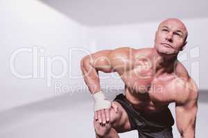 Composite image of bodybuilder exercising against black backgrou