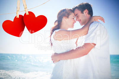 Composite image of happy couple hugging and smiling at each othe