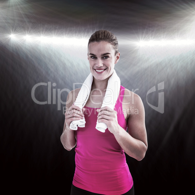 Composite image of muscular woman holding a towel around her nec