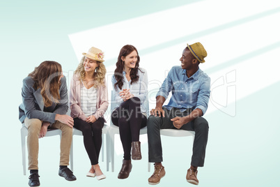 Composite image of smiling business people sitting on chair