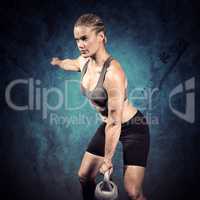 Composite image of muscular woman swinging heavy kettlebell