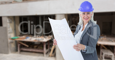 Composite image of selfassured businesswoman wearing a helmet