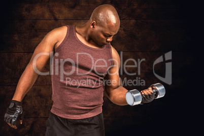 Composite image of fit man exercising with dumbbell