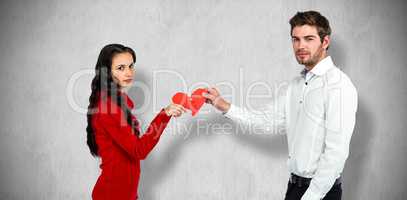 Composite image of portrait of couple holding red cracked heart