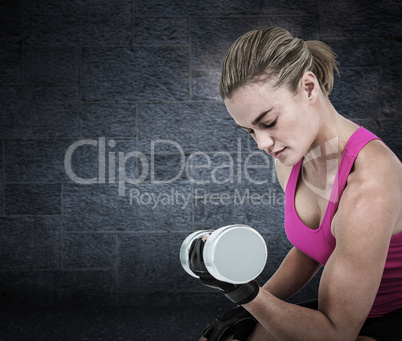 Composite image of muscular woman exercising with dumbbells