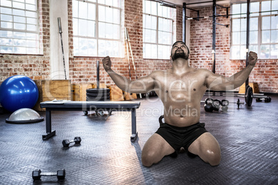 Composite image of muscular man flexing for camera