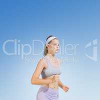 Composite image of sporty focused blonde jogging