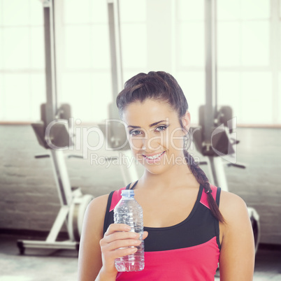 Composite image of fit woman holding water bottle