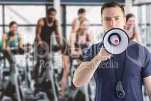 Composite image of male trainer yelling through the megaphone