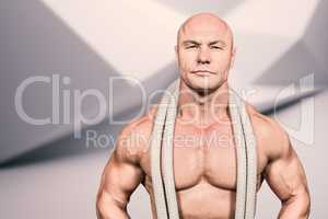 Composite image of portrait of confident fit man with rope aroun