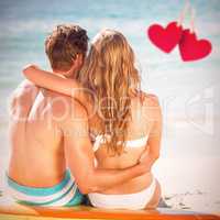 Composite image of happy couple in swimsuit embracing