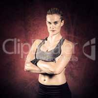 Composite image of muscular woman with arms crossed
