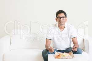 Lonely single man eating food at home