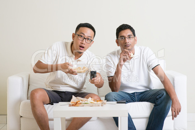 Men friends watching sport match on tv together