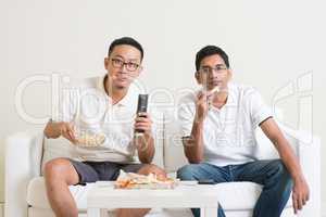 Men watching sport game on tv together