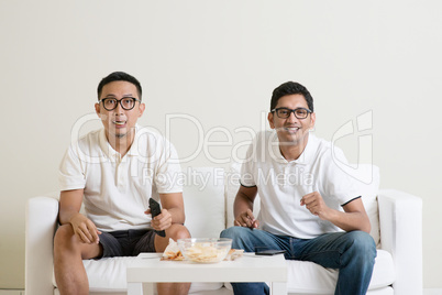 Men watching football game on tv together