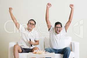 Men watching football game together