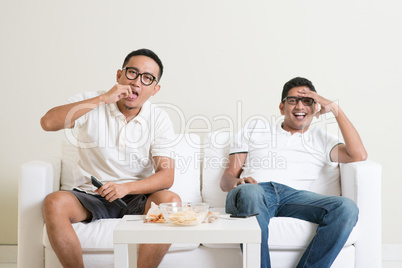Men watching tv together