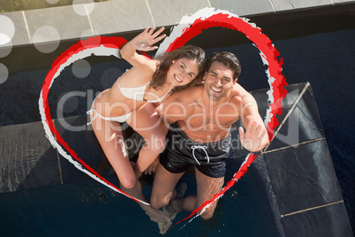 Composite image of above view of a smiling couple waving at the