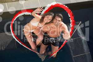 Composite image of above view of a smiling couple waving at the
