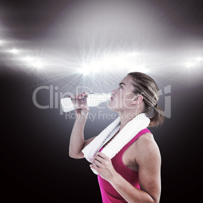 Composite image of fit woman drinking water