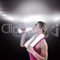 Composite image of fit woman drinking water