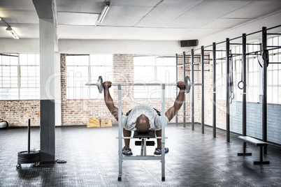 Composite image of fit man exercising with barbell