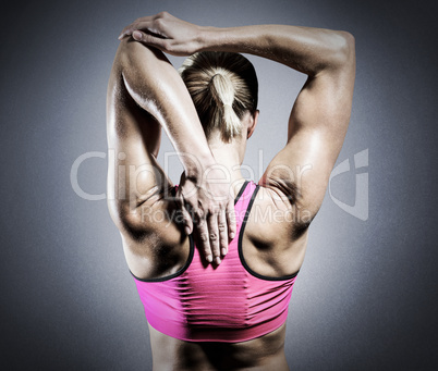 Composite image of muscular woman stretching her arms