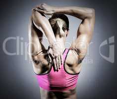 Composite image of muscular woman stretching her arms