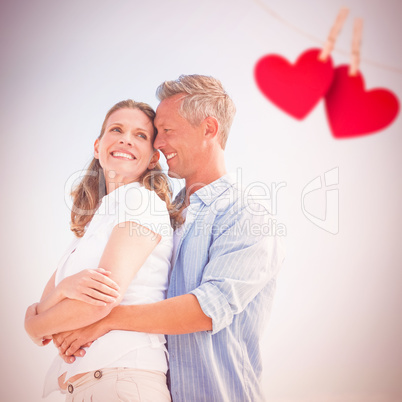 Composite image of happy couple smiling at each other