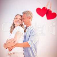 Composite image of happy couple smiling at each other