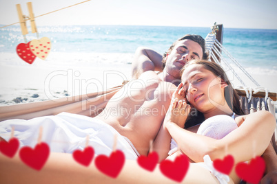 Composite image of happy couple napping together in the hammock