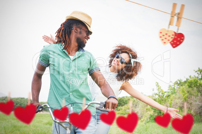 Composite image of young couple on a bike ride
