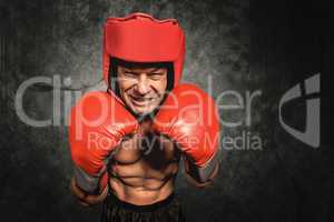 Composite image of angry boxer with gloves and headgear