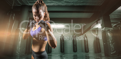 Composite image of portrait of woman with fighting stance