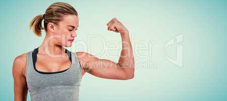 Composite image of serious muscular woman flexing muscle
