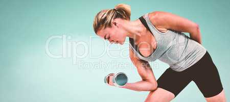 Composite image of  muscular woman working out with dumbbells