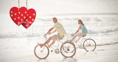Composite image of happy couple on a bike ride