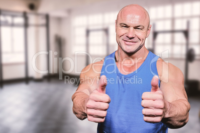 Composite image of smiling healthy man showing thumbs up