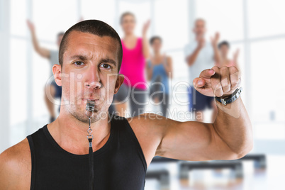 Composite image of portrait of attentive trainer blowing his whi