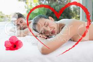 Composite image of couple lying on massage table at spa center