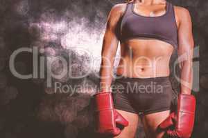 Composite image of midsection of female boxer with gloves