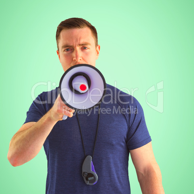 Composite image of male trainer yelling through the megaphone