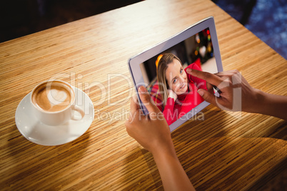Composite image of woman using digital tablet with blank screen
