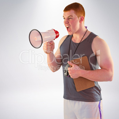 Composite image of angry personal trainer yelling through megaph