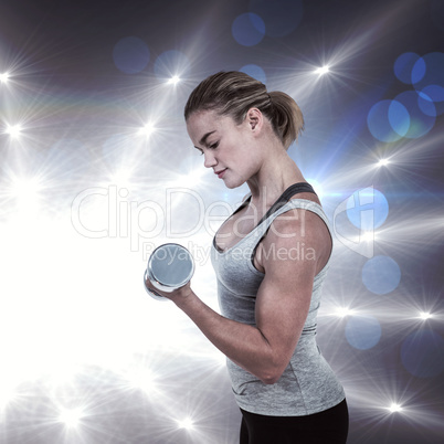 Composite image of  muscular woman working out with dumbbells