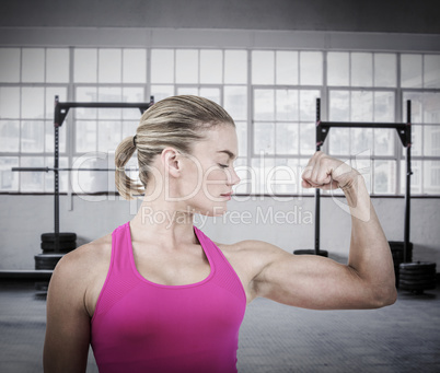 Composite image of mid section of muscular woman flexing muscle