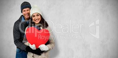 Composite image of festive couple in winter clothes