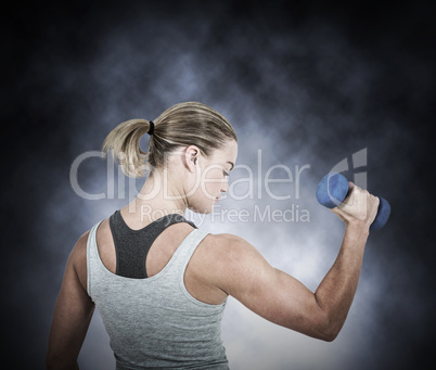 Composite image of  muscular woman working out with dumbbells