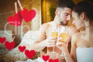 Composite image of romantic couple together with champagne glass